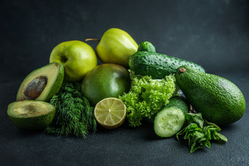 green vegetables and fruits on black background