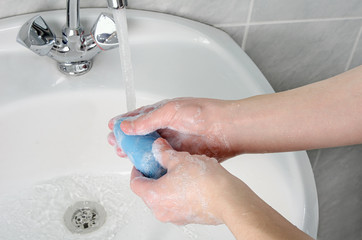 Cleaning hands with soap and tap water in bathroom as protection against bacteria, flu and dirt