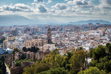 Fototapeta na wymiar Cityscape of Malaga on a cloudy Winter day, with the cathedral and some of the main monuments to be recognised.