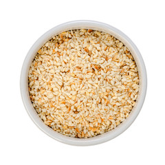 Sesame seeds fried in porcelain round bowl isolated on white background, top view