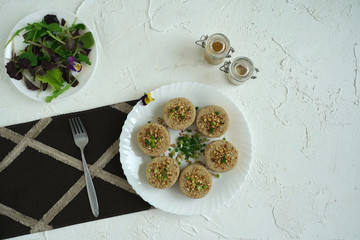 Fototapeta na wymiar Fish cutlets on a white plate with herbs and spices. 