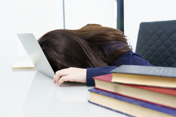 Young woman long hair fall asleep on desk with laptop