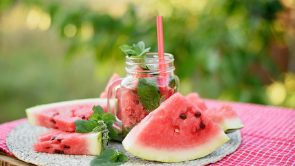 Strawberry and mint infused detox water. strawberry lemonade with ice and mint as summer refreshing drink in jars. Cold soft drinks with fruit.