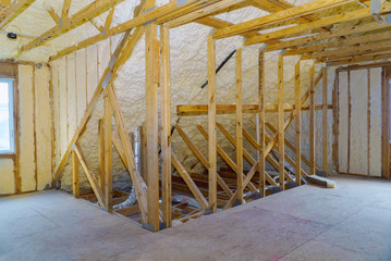 House in unfinished under construction insulation foam the wall roofing of a attic