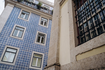 Fototapeta na wymiar Architecture with azulejo tiles in the Old Town of Lisbon, Portugal. Buildings at the street corner