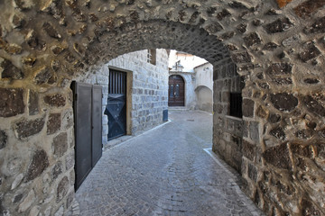 A narrow street between the old houses of the village of Faicchio in the province of Benevento, Italy