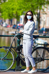Fototapeta na wymiar Young woman on bike in european city