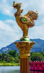 Fototapeta na wymiar Row of golden rooster statues in buddhist temple