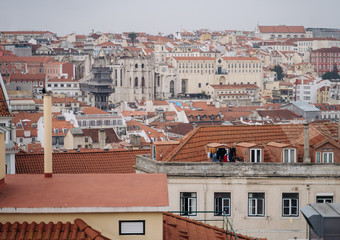 Fototapeta na wymiar View of Santa Justa elevator and Carmo church ruins over Lisbon red tiled roofs