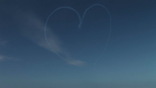 Heart shape being made in the sky by a plane UK 4K