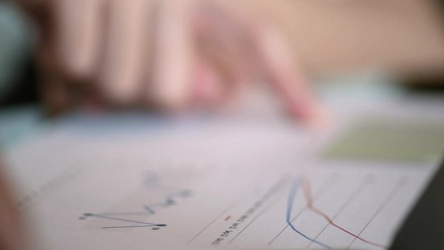 Diverse businessman working together with statistics, Hand forefinger point to drawing graph explaining new idea for business improvement to workmate project team. teamwork group meeting explain.