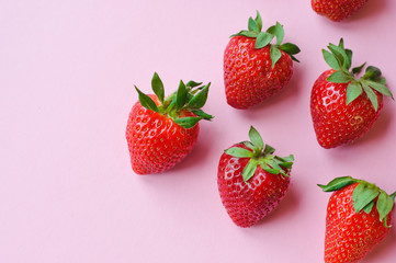 Top view of pile of strawberries on white surface with blank copy space