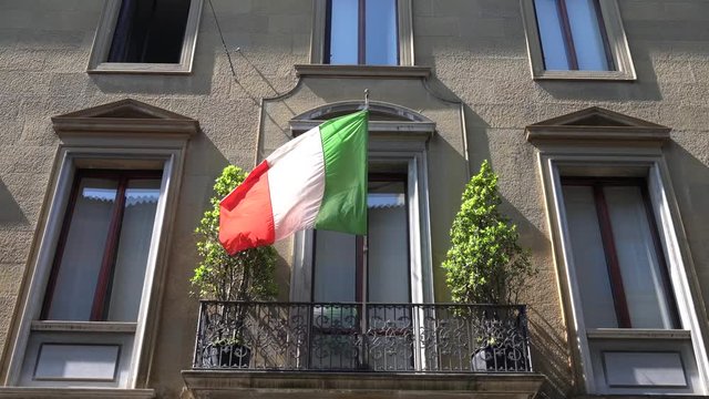 Italy, Milan April 25, 2020  day of the Resistance during covid 19 Coronavirus quarantine at home - Italian flash mob with flag  on the windows , balconies of the house
