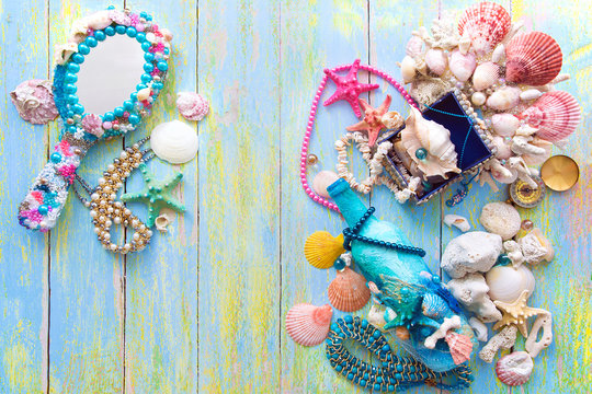 mermaid's treasures on a light peeled wooden light background with scratches and blur flat lay out of focus