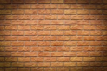 Brick texture. Orange background. Brown wallpaper for designer. Rectangular photo with dark vignetting.