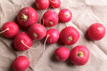Scattered radish on burlap, top view
