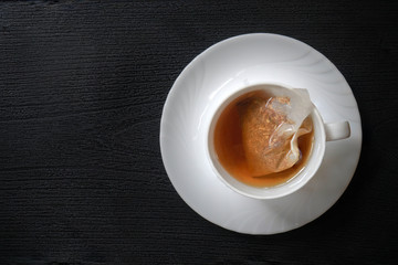 Tea bags in a white coffee mug (Tea bags release billions of micro-plastics and nano-plastics into tea)