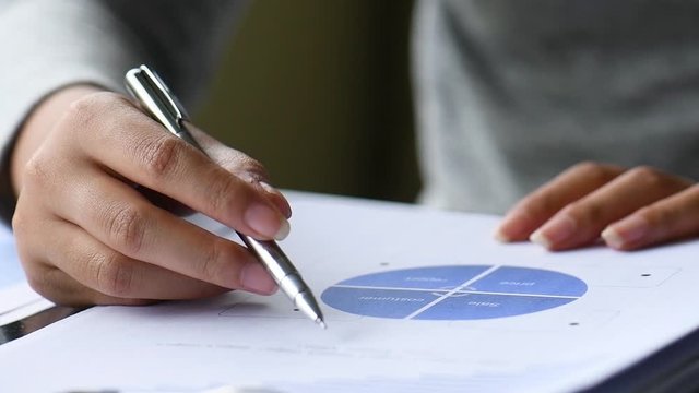 Diverse businessman working together with statistics, Hand forefinger point to drawing graph explaining new idea for business improvement to workmate project team. teamwork group meeting explain.