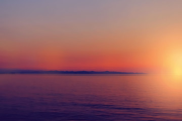 Beautiful defocused blurred sunset or sunrise sea view as background for your creative design. Local tourism concept