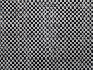 black and white checkered fabric with a visible texture. background or texture, closeup.
