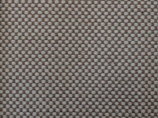 Fototapeta premium beige-brown checkered fabric with visible texture. background or texture, closeup