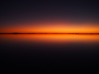 Naklejka premium Sunrise on the world's largest salt flat, Uyuni Salt Flat, Salar de Uyuni, Bolivia. Copy space for text
