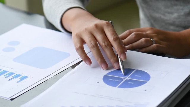 Diverse businessman working together with statistics, Hand forefinger point to drawing graph explaining new idea for business improvement to workmate project team. teamwork group meeting explain.