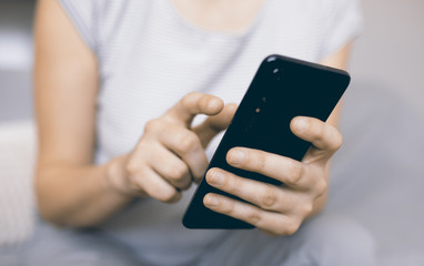 Smiling young woman with mobile. Surfing the internet concept,social media. Young woman using her smart phone. Smart phone with social media icons