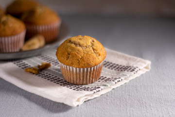 Muffins on Gray Table Linen with Sliced Bananas and Walnuts