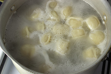 dumplings are cooked in a pot