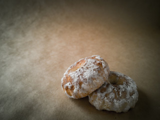 Sweet round gingerbread cookies with white sugar icing top view on a wooden stand. Delicious soft wheat gingerbread for tea or a glass of milk .