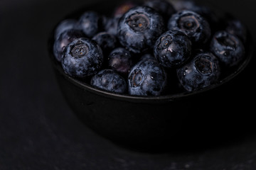 Fresh blueberry bowl. Dark food photography