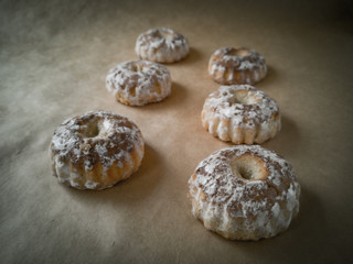 Sweet round gingerbread cookies with white sugar icing top view on a wooden stand. Delicious soft wheat gingerbread for tea or a glass of milk .