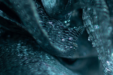 Background and backsplash of wet net with moist crystal water drops stuck between strings - abstract structure, technology, design, london blue topaz macro