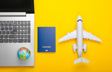 Travel still life. Online booking. Emigration. Laptop, globe, plane and passport. Tourist...