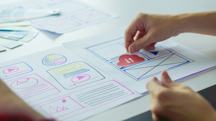 Designers man drawing (UX) (UI) Graphic designer creative sketch planning application process development prototype for application on smartphone. selective focus, copy space,
