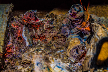 Embers and burning firewood in the stove