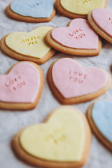 Obraz na płótnie Canvas Valentine's Day presents: Heart-shaped cookies with colorful glaze and themed lettering for all lovers