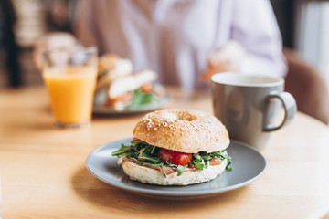 delicious and appetizing breakfast: a bagel stuffed on a plate