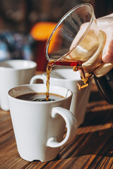 The coffee is alternatively made using a paper filter and a kemex is poured from the flask into a...