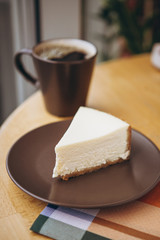 Piece of cake with coffee for breakfast on the table in a coffee shop