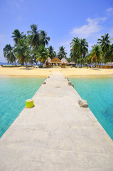 Bridge to a tropical Caribbean island surrounded by clear blue waters