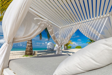 Fototapeta na wymiar Amazing summer vacation background. Luxury scenery of beach with white beach canopy and loungers. Relaxing paradise island, luxurious tropical landscape. Dream scene, serenity beach, lounge canopy 