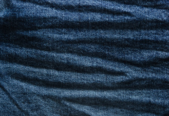 Crumpled jeans texture closeup. Denim texture