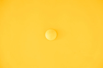 Yellow ball on yellow background. Minimal concept. Top view. Copy, empty space for text