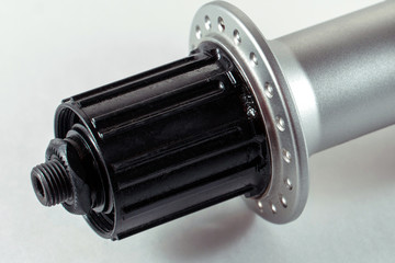 Bicycle repair. Mountain bike workshop. Rear hub under the disc brake on a white background. The...