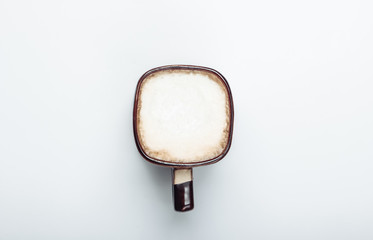 Cup of latte or cappuccino on a white background. Coffee with milk. Top view