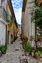 A narrow street between the old houses of a village in the province of Benevento, Italy