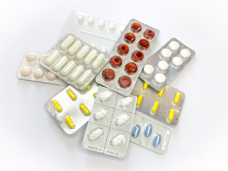 Many plenty a lot of tablets in blister pack, pills, capsules on a white background