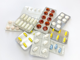 Many plenty a lot of tablets in blister pack, pills, capsules on a white background